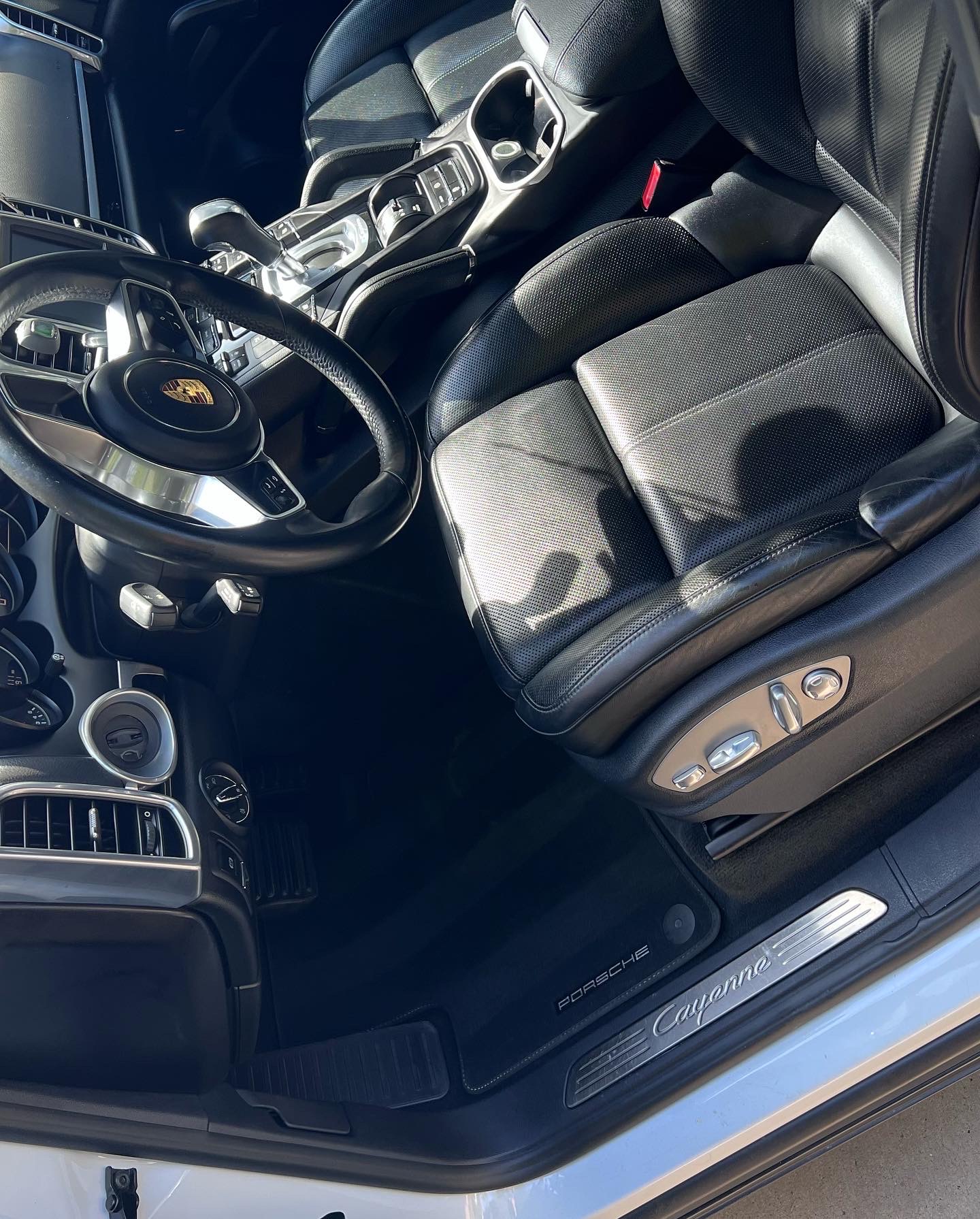 Clean Porsche Cayenne front interior with leather seats and center console